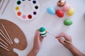 Woman painting Easter eggs at home. family preparing for Easter. Royalty Free Stock Photo