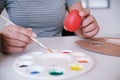 Woman painting Easter eggs at home. family preparing for Easter. Royalty Free Stock Photo