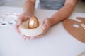 Woman painting Easter eggs at home. family preparing for Easter. Royalty Free Stock Photo