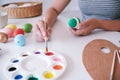 Woman painting Easter eggs at home. family preparing for Easter. Royalty Free Stock Photo