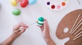 Woman painting Easter eggs at home. family preparing for Easter. Hands of a girl with a easter egg Royalty Free Stock Photo