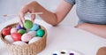 Woman painting Easter eggs at home. family preparing for Easter. Hands of a girl with a easter egg Royalty Free Stock Photo