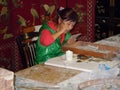 Woman painting glass panels with brush