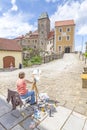 Woman painting Hohnstein castle.