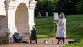 A woman painting a picture in the open air. Hobby in the park.