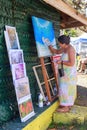 Woman painting sea turtle at outdoor market, Rarotonga, Cook Islands