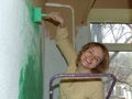 Woman painting a wall green Royalty Free Stock Photo