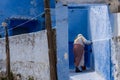 Woman painting walls iin Chefchaouen Royalty Free Stock Photo