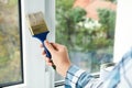 Woman painting window frame at home Royalty Free Stock Photo