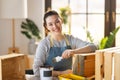 Woman is painting a wooden crate