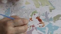 Woman paints acrylic paints painting by numbers, the antistress hobby. 1080p video