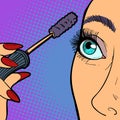 Woman paints eyelashes, makeup