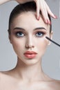 Woman paints eyes and eyelashes brush for eyelashes. Increase in volume of eyelashes, cosmetics for eye care. Beautiful female