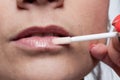 Woman paints lips Royalty Free Stock Photo