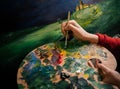 woman paints a picture with paints artist easel palette Bright colors