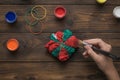 A woman paints tie dye-style clothes in red and green Royalty Free Stock Photo