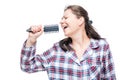 Woman in pajamas singing in hairbrush before going to bed