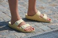 Woman with pale yellow Birkenstock sandals before MSGM fashion show Royalty Free Stock Photo