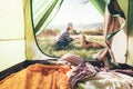 Woman pand her dog tender scene near the camping tent. Active leisure, traveling with pet concept image Royalty Free Stock Photo