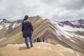 Woman with panoramic view. Hiking scene in Vinicunca, Cusco region, Peru. Montana of Seven Colors, Rainbow Mountain