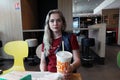 Woman With Paper Cup Of Coca-Cola At McDonald