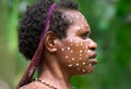 The woman of a Papuan tribe in traditional clothes and coloring