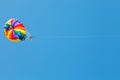 Woman parakiting on parachute in blue sky