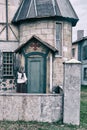 A girl parishioner in a headscarf is facing the door of a vintage Church