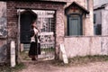 A woman parishioner at the wicket  of an ancient Church in the style of architecture of medieval Europe Royalty Free Stock Photo