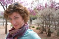 Woman in park with blooming flowers Royalty Free Stock Photo