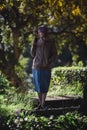 A woman in the park drinking yerba mate.