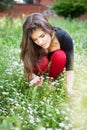 Woman in park gather spring flowers