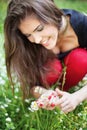 Woman in park gather spring flowers