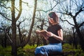 Woman in park outdoor with tablet and book