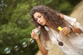 Woman in the park playing in bubbles cup Royalty Free Stock Photo