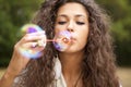 Woman in the park playing in bubbles cup Royalty Free Stock Photo