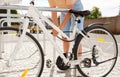 woman parking her bicycle on city street