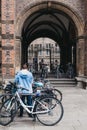 Woman parks her bike on the street in Cambridge, UK