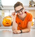 Woman in party bat glasses in the Halloween decorated kitchen