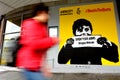 Woman pass by Graffiti with the political slogan Refugees Welcome