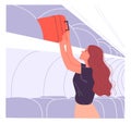 Woman passenger puts her hand baggage on the overhead shelf.