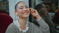 Woman passenger smiling camera waiting departure train close up. Girl listening Royalty Free Stock Photo