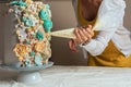 Woman pastry chef decorating a cake with a pastry bag with cream Royalty Free Stock Photo