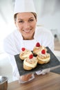 Woman pastry chef with fresh deserts