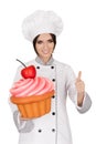 Woman Pastry Chef Holding Huge Cupcake Giving Thumbs up Sign Royalty Free Stock Photo