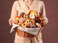 woman pastry chef holds a basket with various delicious cookies