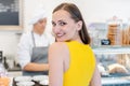 Woman in the pastry shop choosing sweet desserts Royalty Free Stock Photo