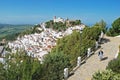 Woman on pathway with town to rear, Casares, Spain.