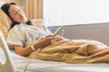 Woman patient hand using remote control for adjust level bed in hospital. Royalty Free Stock Photo