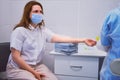 Woman patient in hospital waiting for injection with coronavirus vaccine. Doctor giving an injection to a woman for a vaccine for Royalty Free Stock Photo